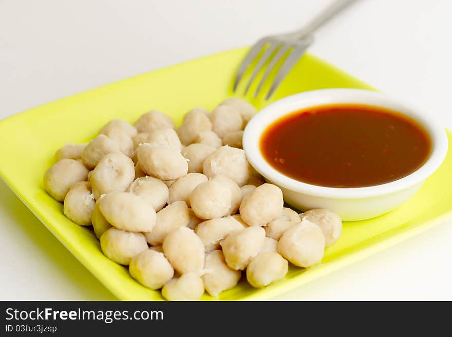 Meatballs on the green dish and spicy Thai style sauce