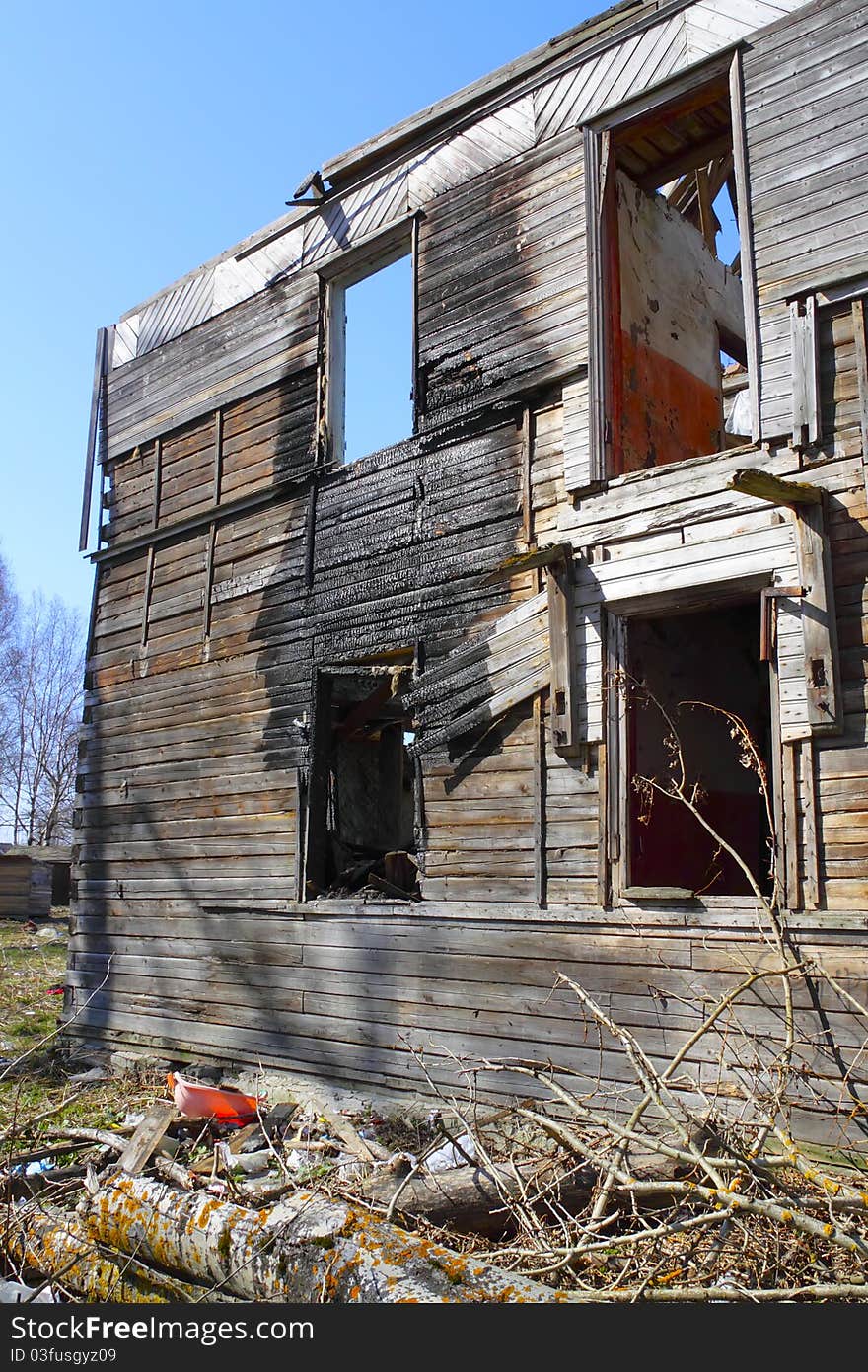 Skeleton of burnt house in the background of blue sky. Skeleton of burnt house in the background of blue sky