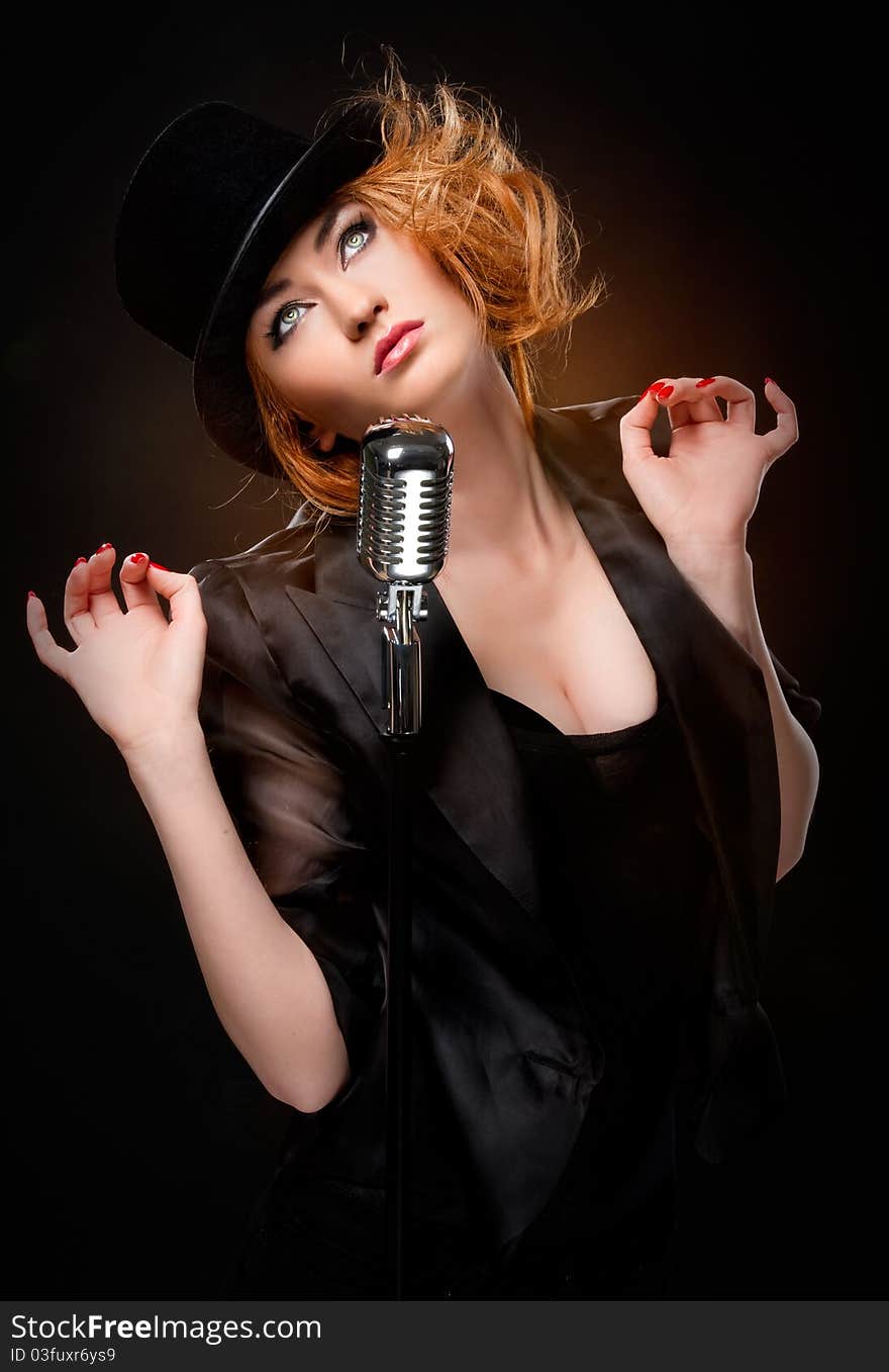 Gorgeous stylish redhead woman with retro microphone. Gorgeous stylish redhead woman with retro microphone