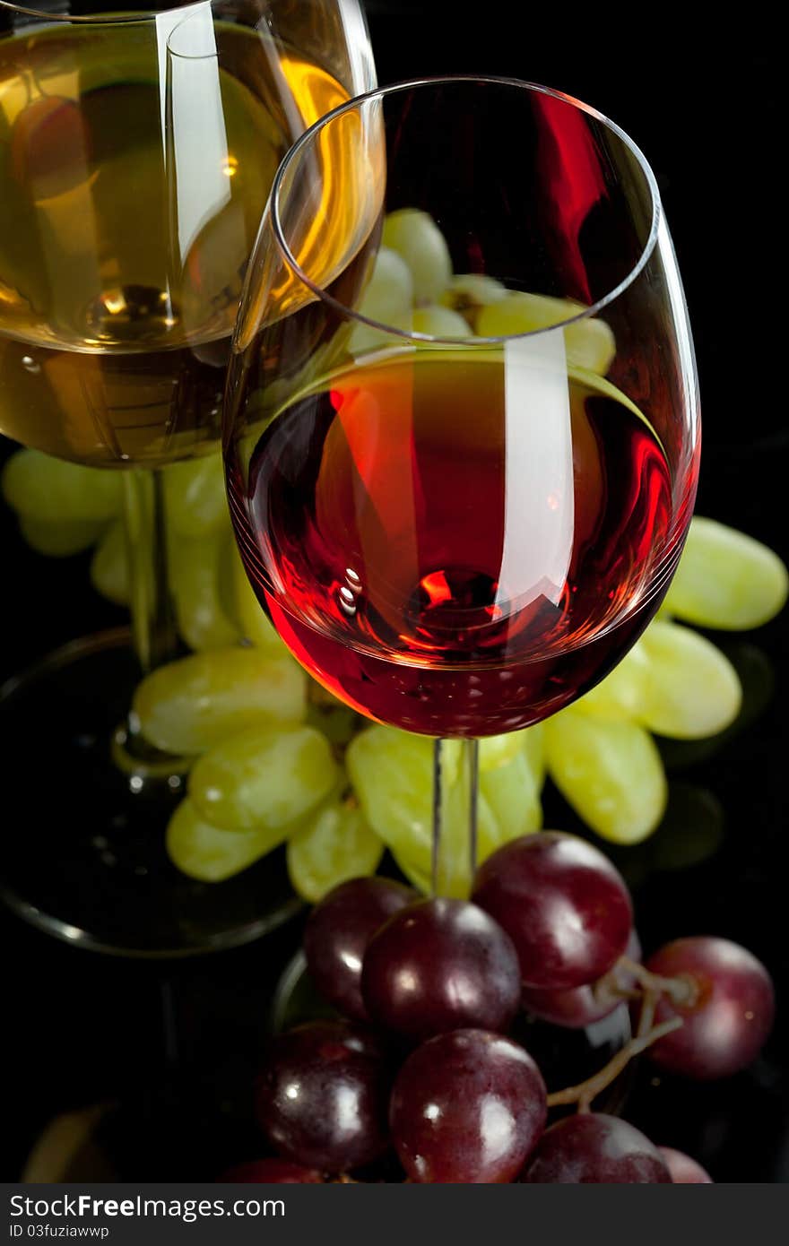 Red And White Wine In Glasses With Grape