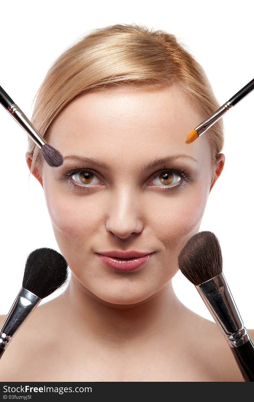 Smiling woman with make up brushes isolated