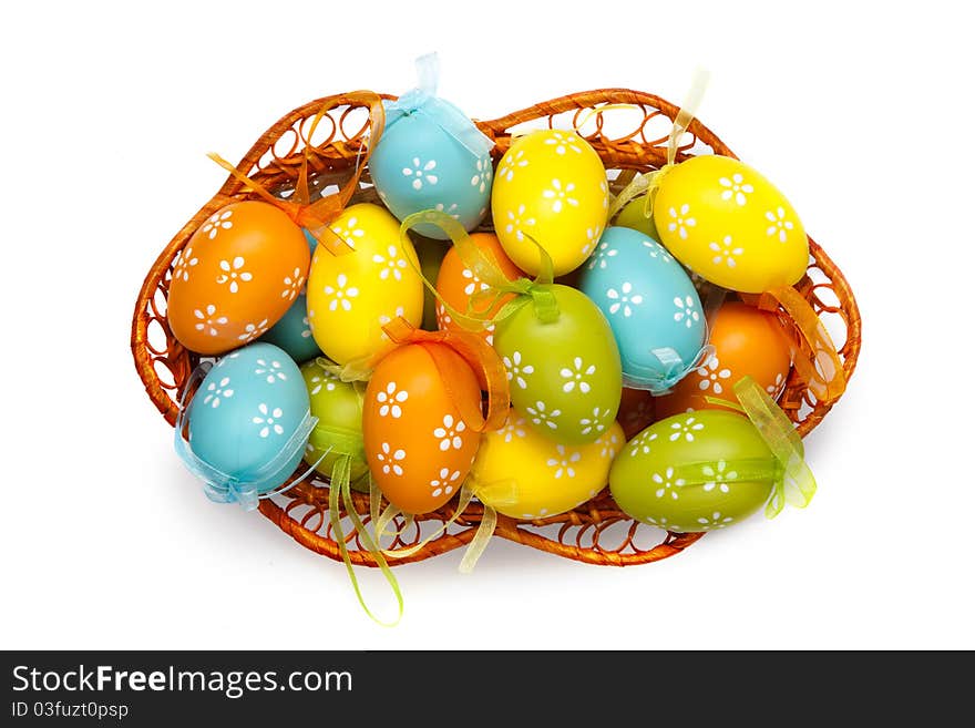 Easter eggs in basket isolated on white. top view