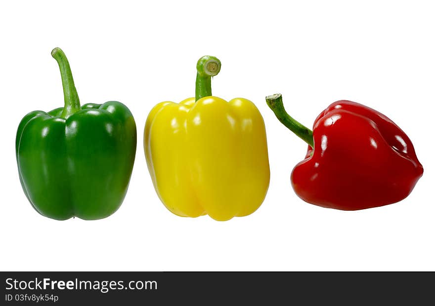 Three peppers, red, yellow, green, white background.