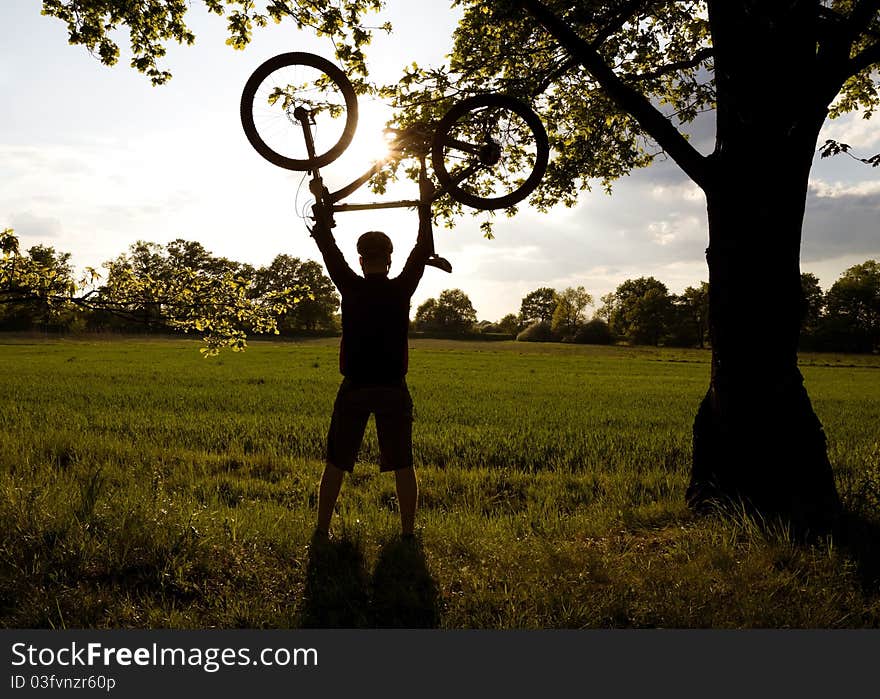 Mountain biker silhouette in summer nature. Mountain biker silhouette in summer nature