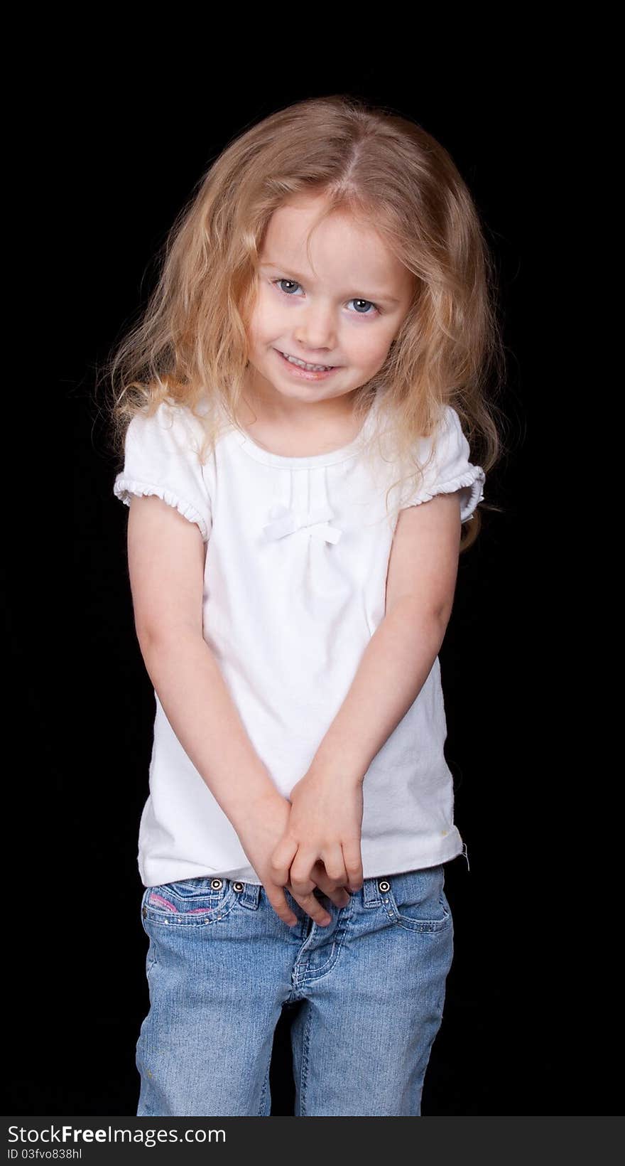 A sly young girl is smiling sneakly at the camera. A sly young girl is smiling sneakly at the camera.