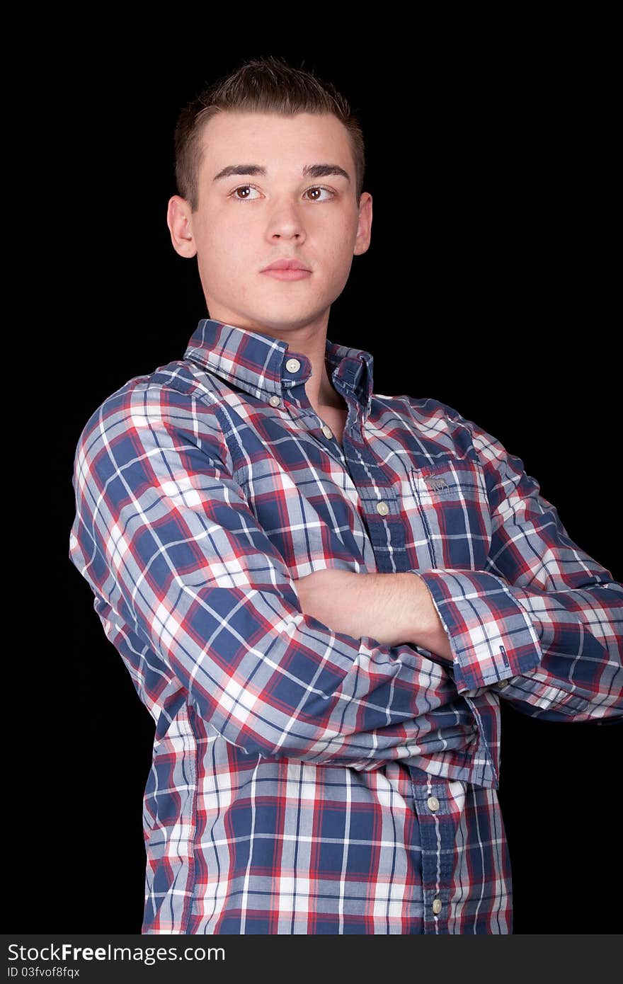 A handsome young man with a black background. A handsome young man with a black background.