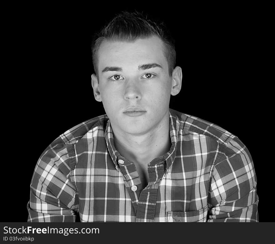 A handsome young man with a black background. A handsome young man with a black background.