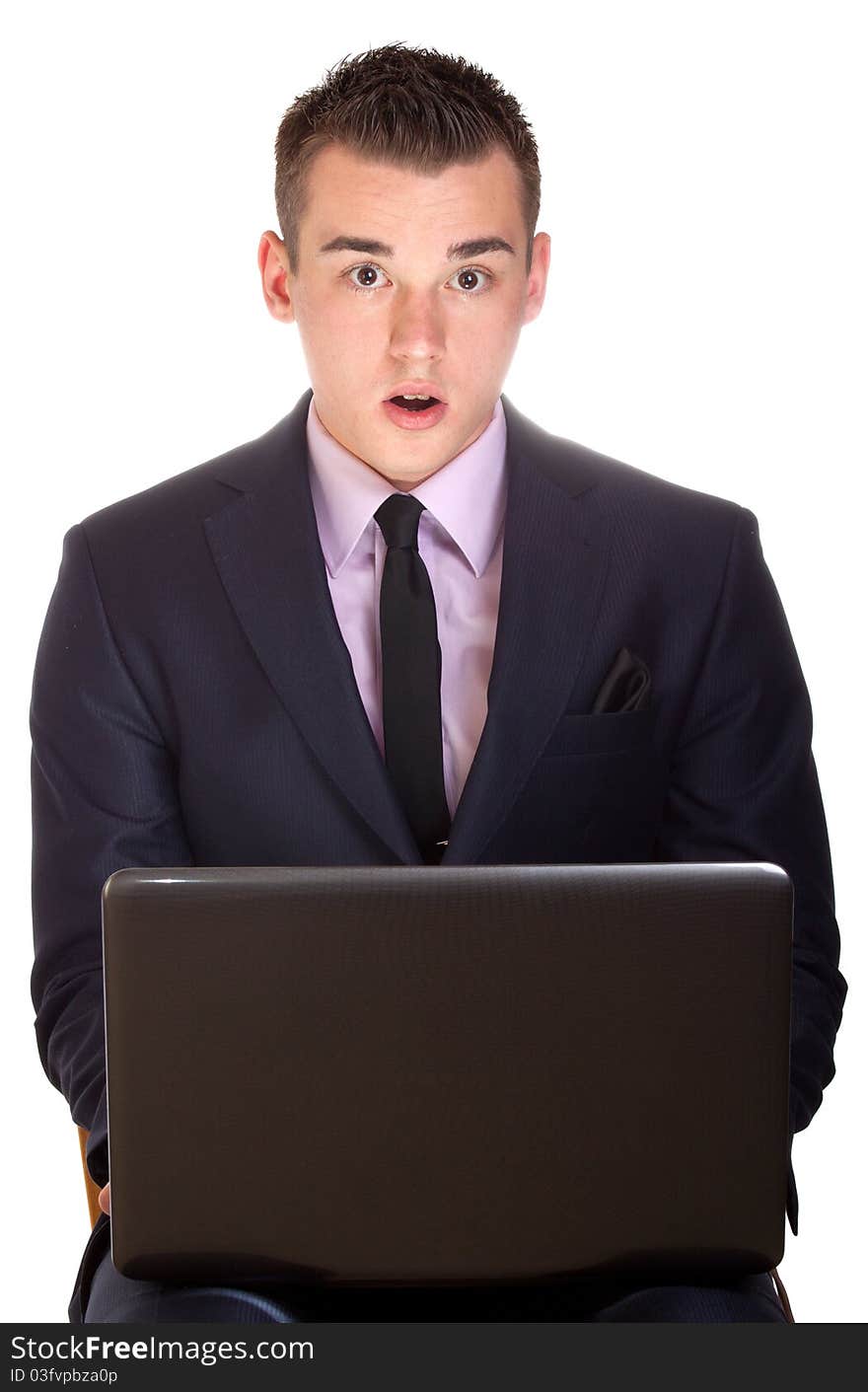 A photograph of a young executive excited with his laptop. A photograph of a young executive excited with his laptop.