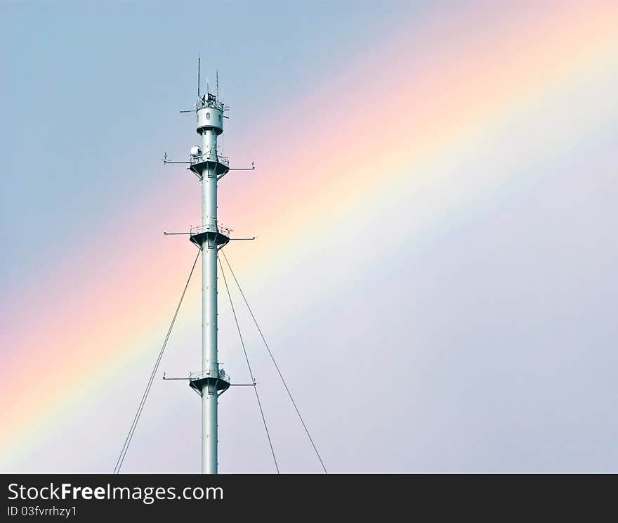 Radio mast against a rainbow after a thunder storm. Radio mast against a rainbow after a thunder storm