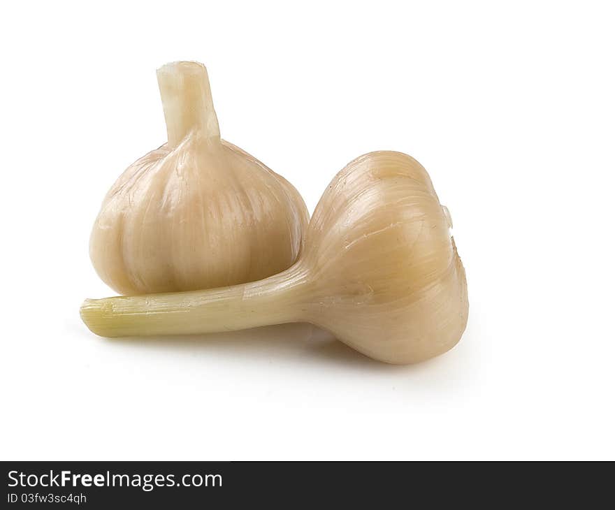 Two marinated head of garlics on the white background. Two marinated head of garlics on the white background