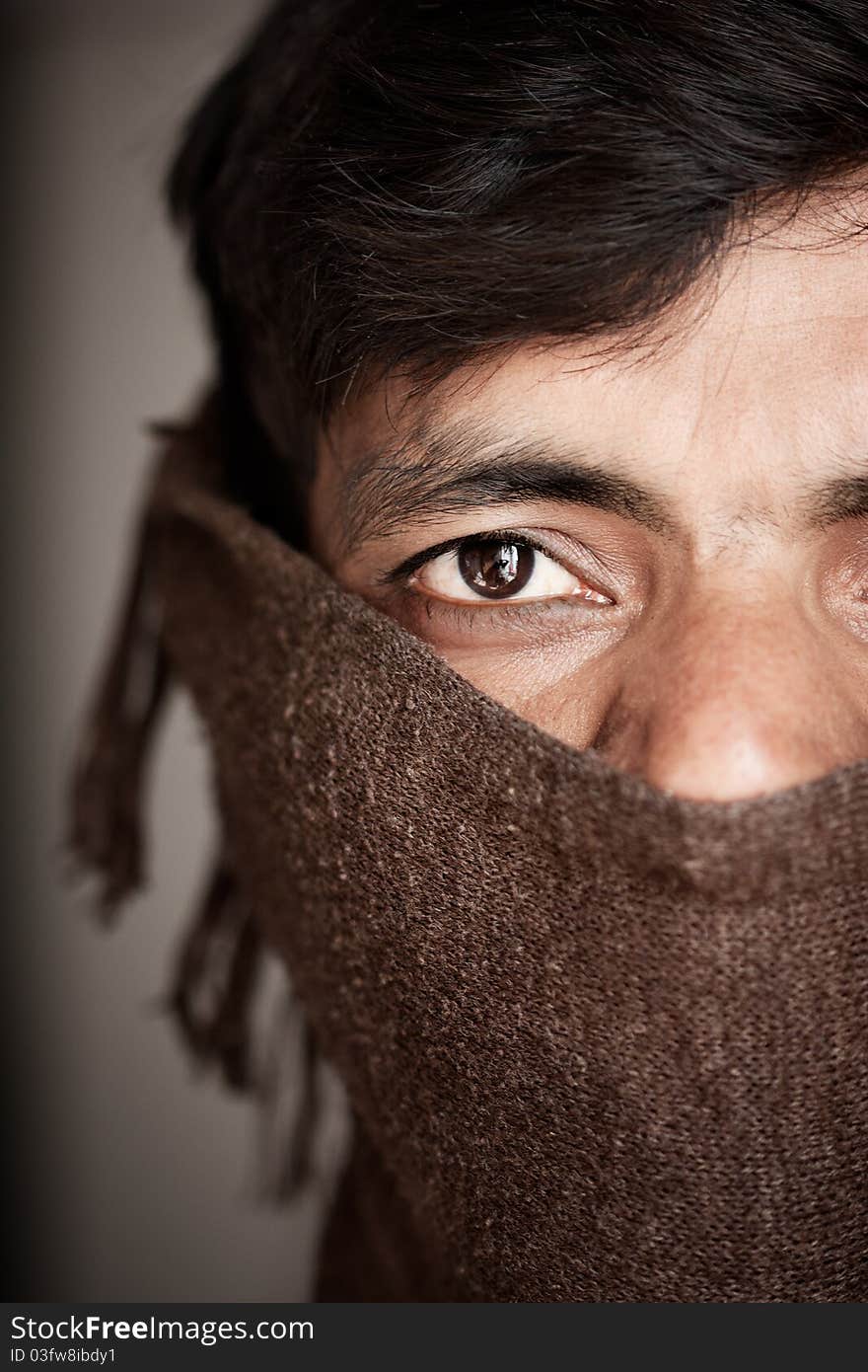 Indian man covered face by woolen scarf