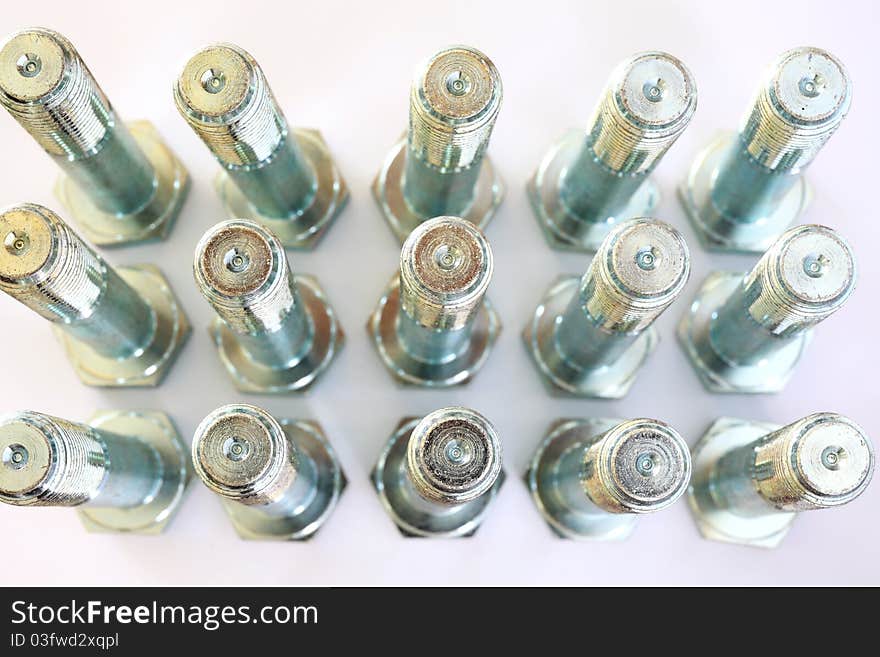 Metal bolts over white background