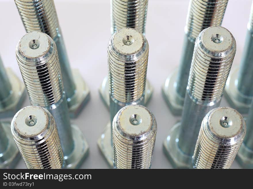 Metal Bolts Over White Background And Closeup