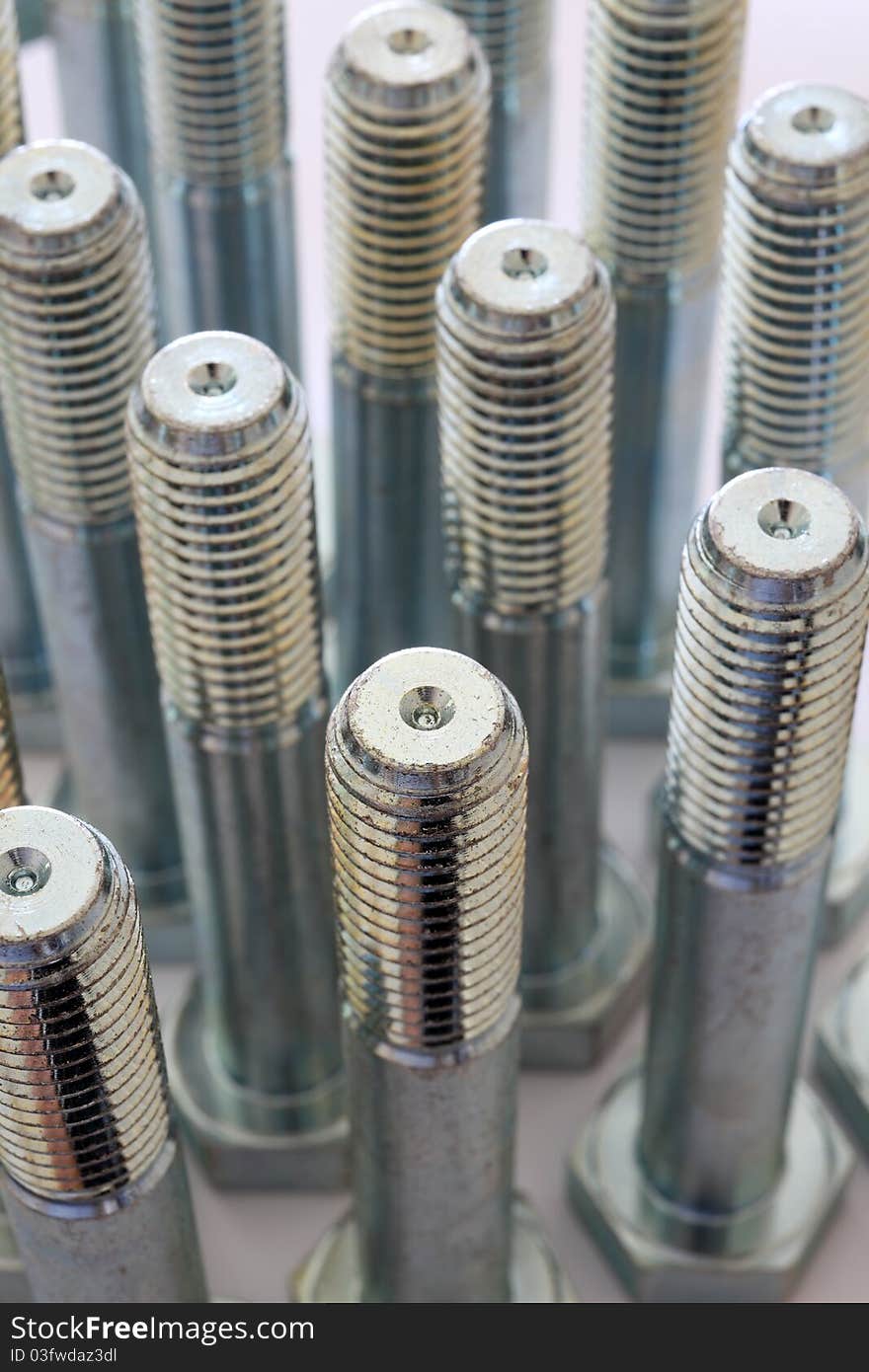 Metal Bolts Over White Background And Closeup