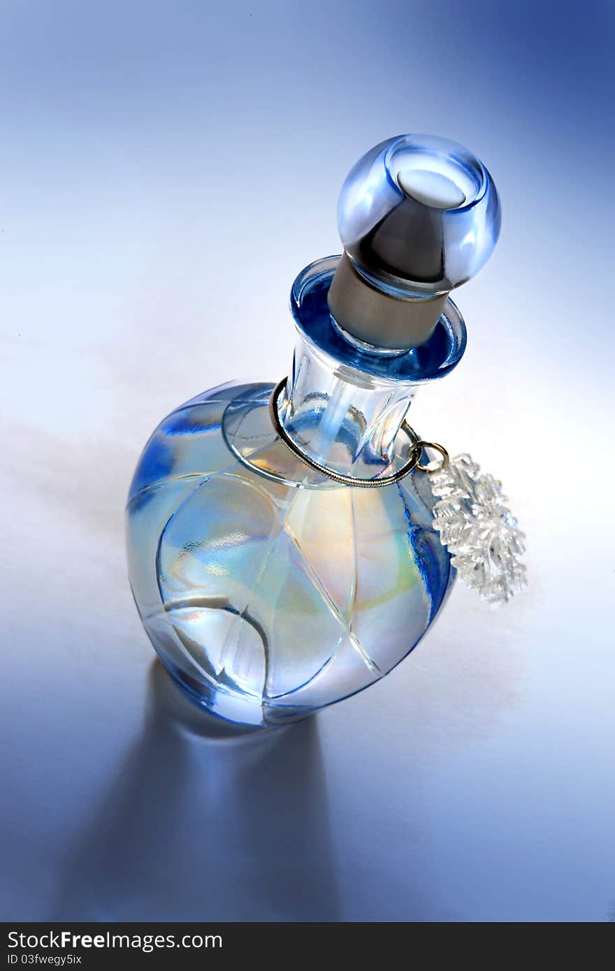 Blue perfume bottle on blue background