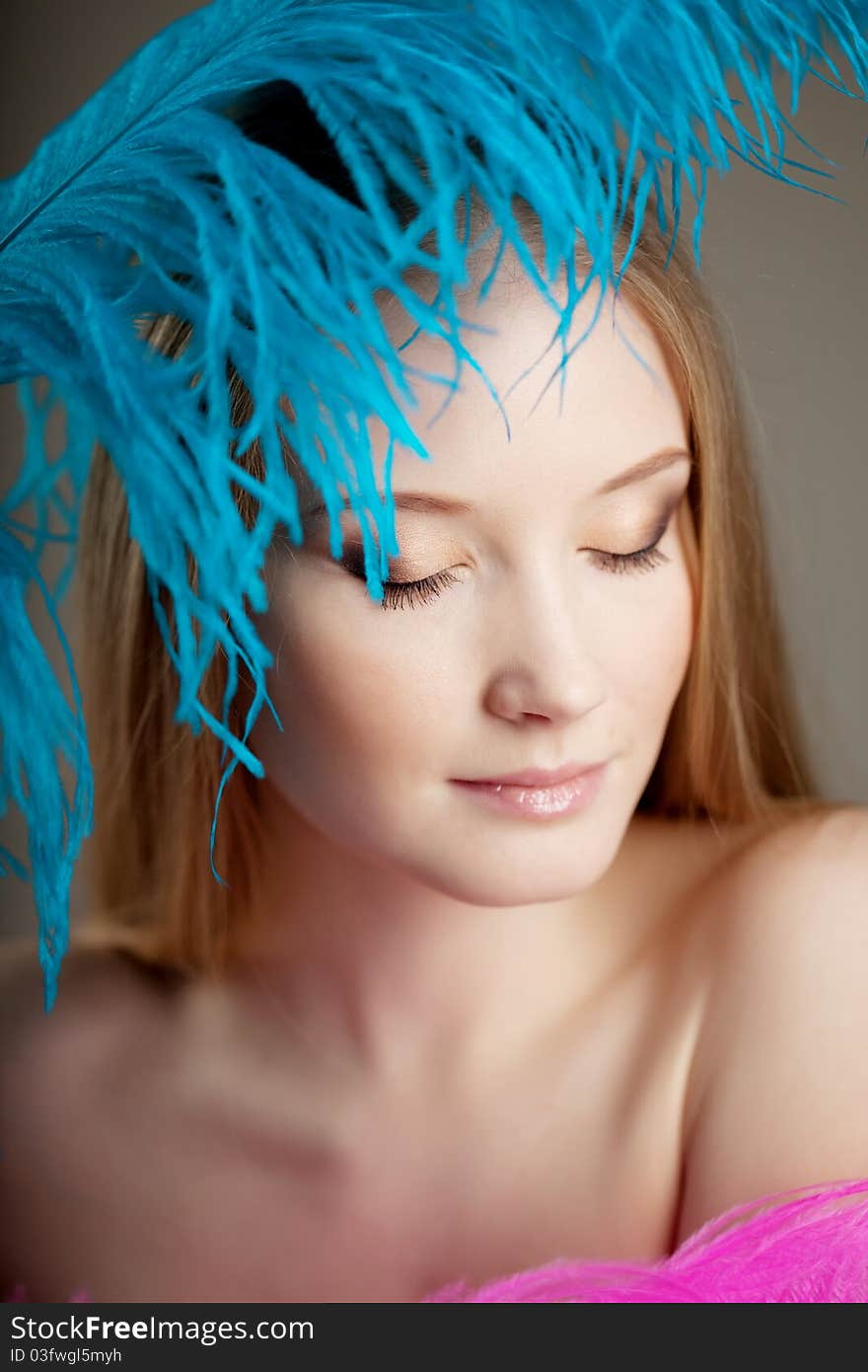 Beautiful girl with colorful feathers