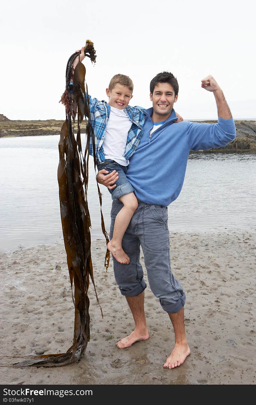 Father and son on beach smiling