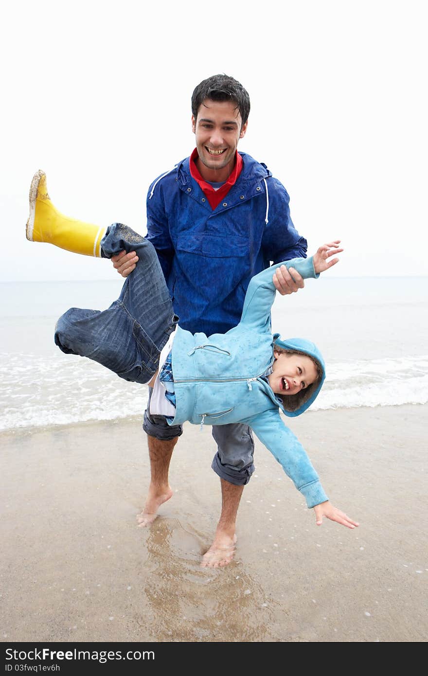 Happy father with son on beach playing