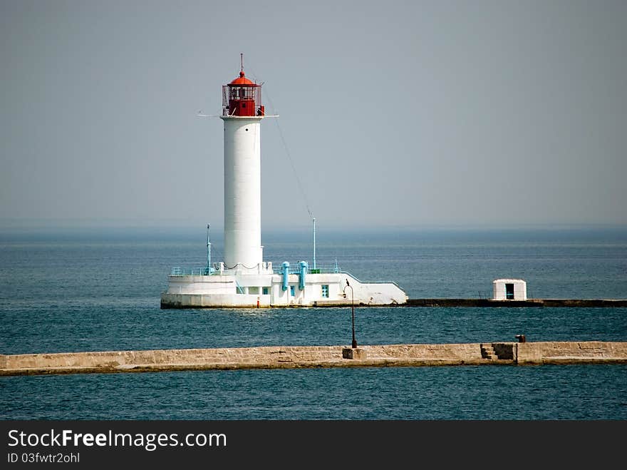 Lighthouse in the sea and the breakwater in front of it