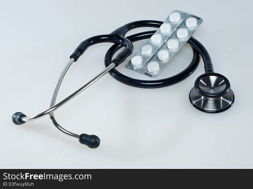 Medical concept with pills and stethoscope. Medical concept with pills and stethoscope