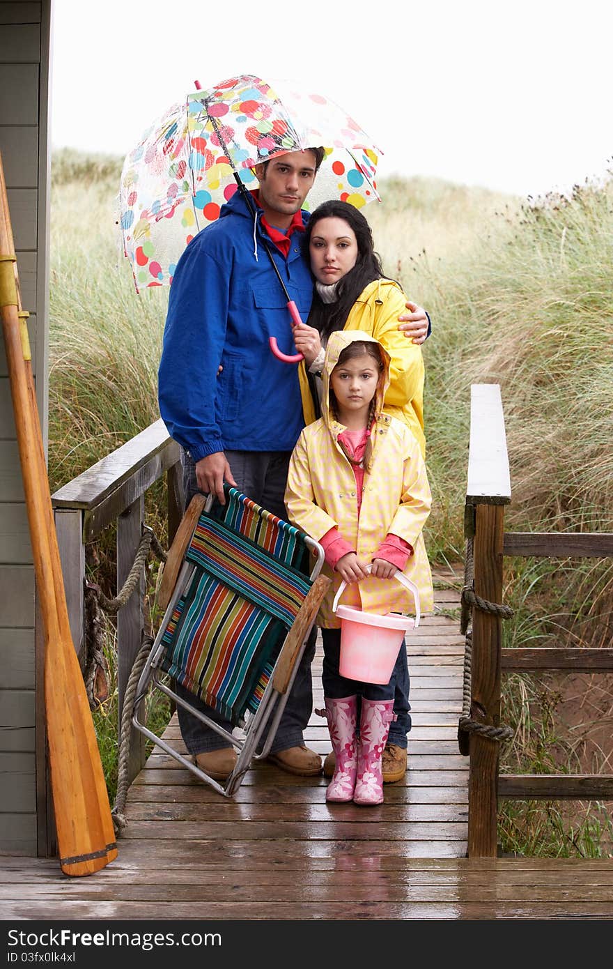 Family on beach with umbrella