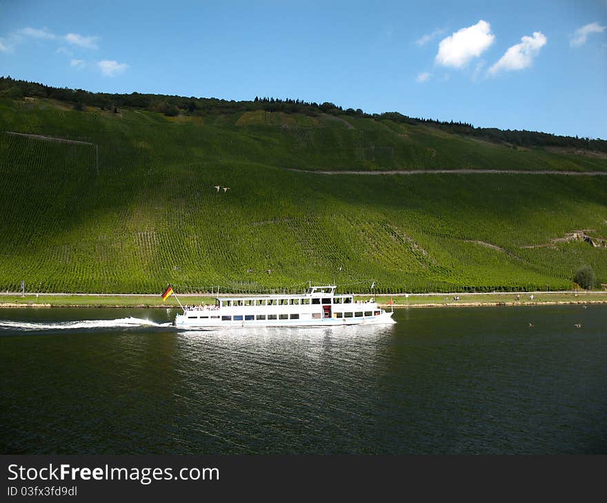 Shadows on vineyard and ferry on river Mosel.