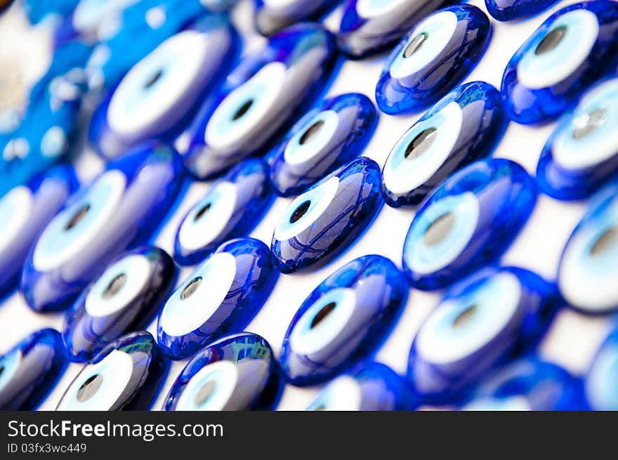 Close up texture of many blue glass beads worn to avoid evil eyes in Turkey. Close up texture of many blue glass beads worn to avoid evil eyes in Turkey