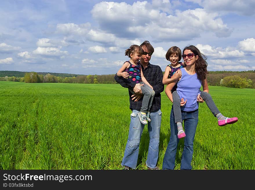 Parents giving their kids piggyback ride. Parents giving their kids piggyback ride