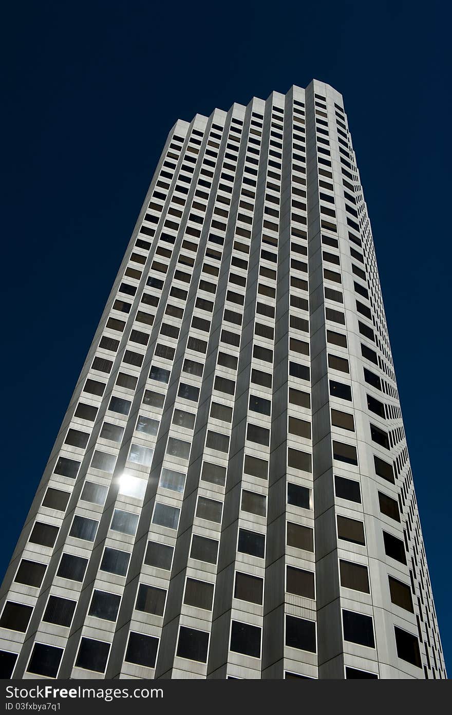 Skyscraper with sunlight reflection in window. Skyscraper with sunlight reflection in window.