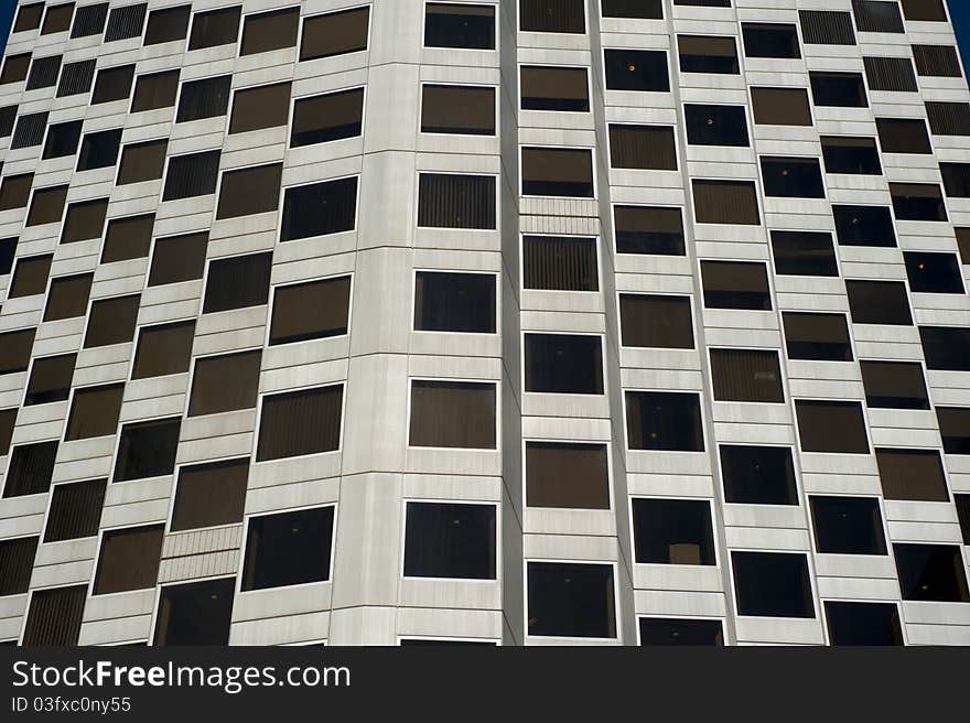 Detailed image of office block and the many square sized windows along the facade. Detailed image of office block and the many square sized windows along the facade.