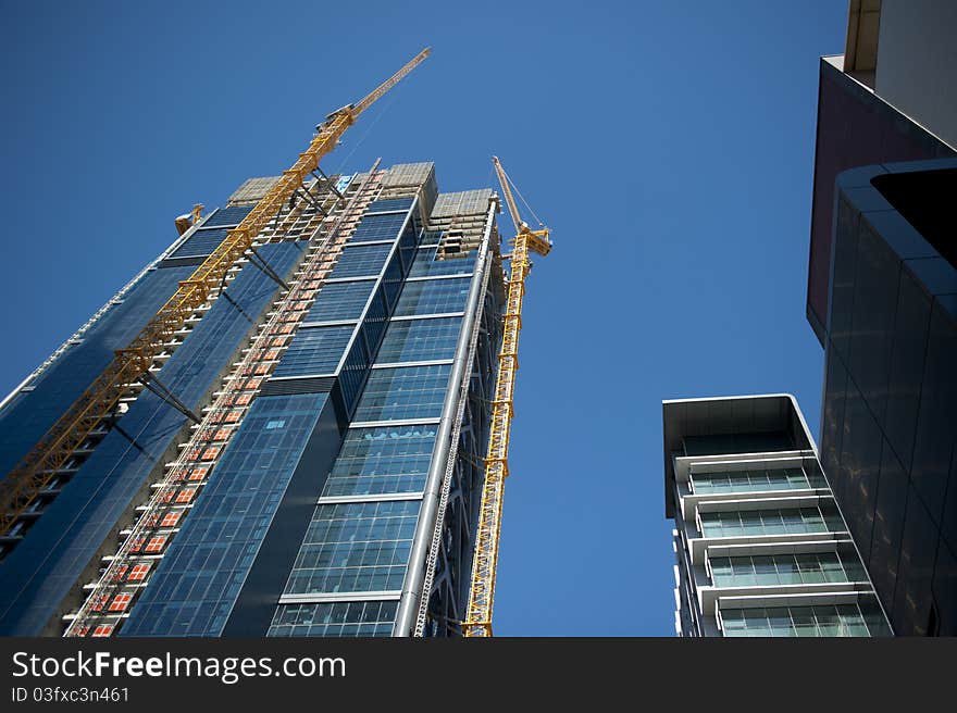 Upward view along a crane at a construction site in Perth Business District, Australia. Upward view along a crane at a construction site in Perth Business District, Australia.