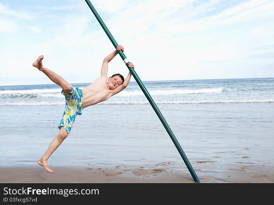 Teenagers playing on beach smiling