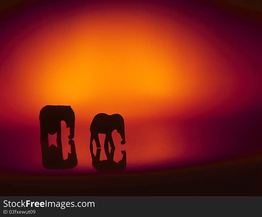 Elephant still-life exhibit. High contrast silhouette of mother and calf. Elephant still-life exhibit. High contrast silhouette of mother and calf.