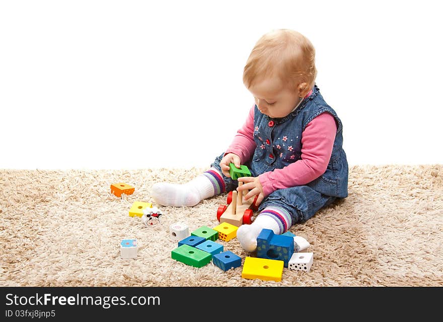 Little girl playing with wood train. Little girl playing with wood train