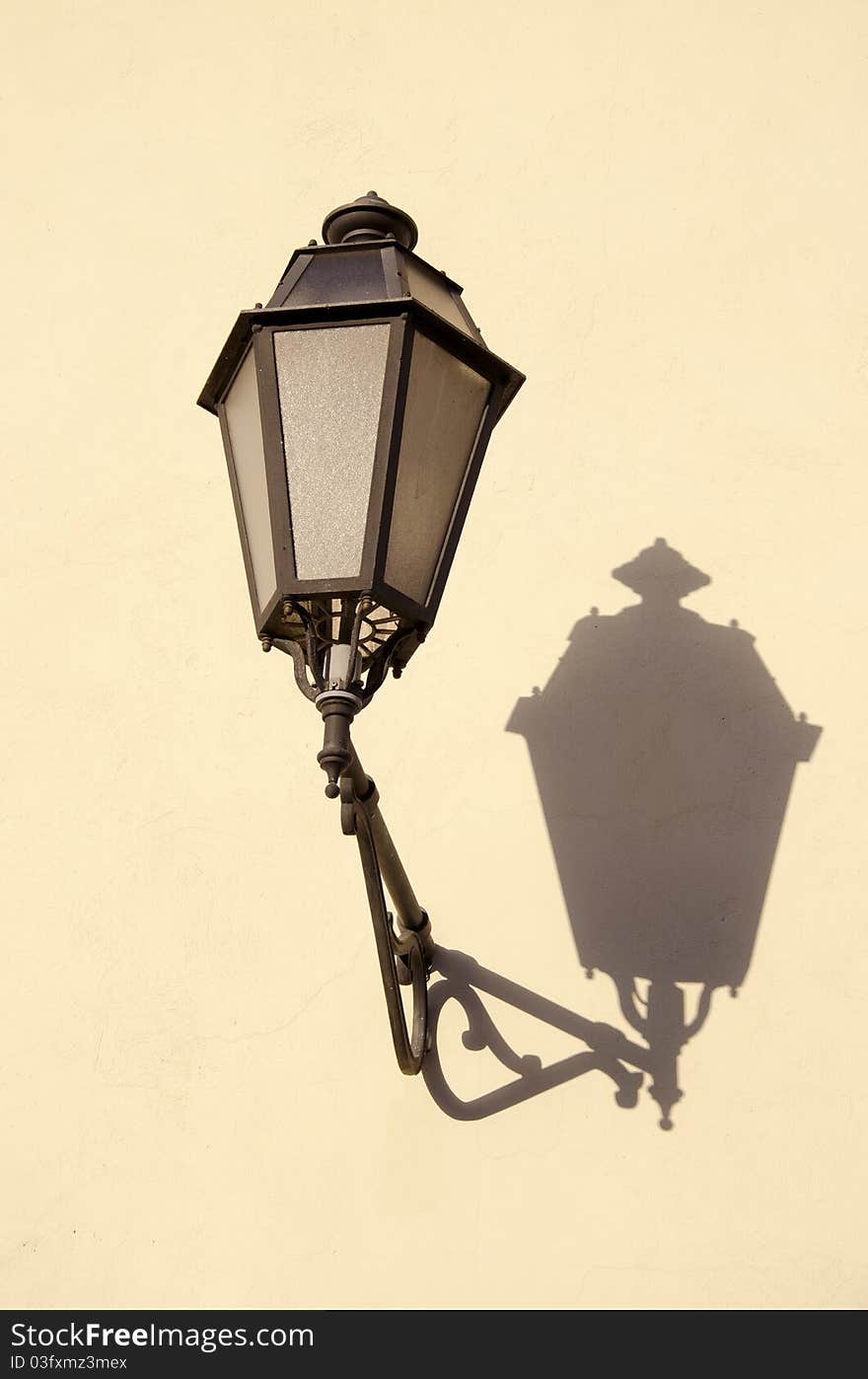 Old town vintage lamp on wall and shadow