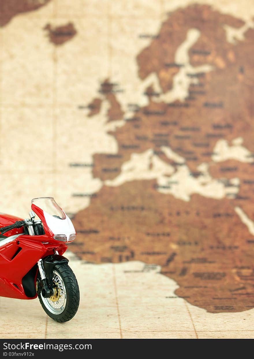 Red motorcycle in front of a world map. Red motorcycle in front of a world map