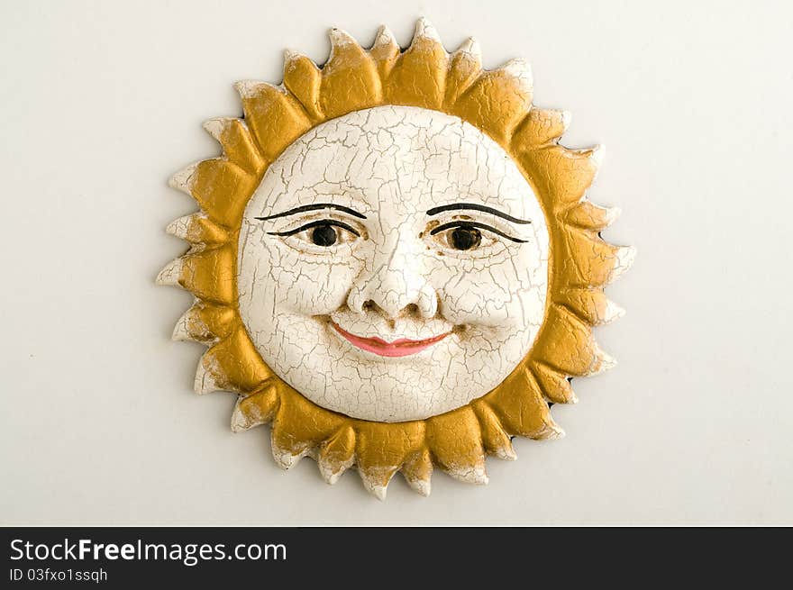 Handmade ornamental sun face with rays made by terracotta. Handmade ornamental sun face with rays made by terracotta