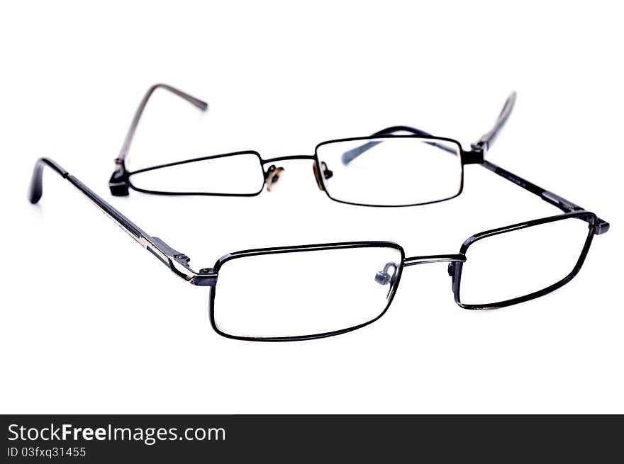 Broken black eyeglasses isolated on a white background