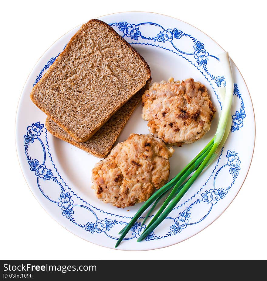 Cutlets, bread and onion on the plate