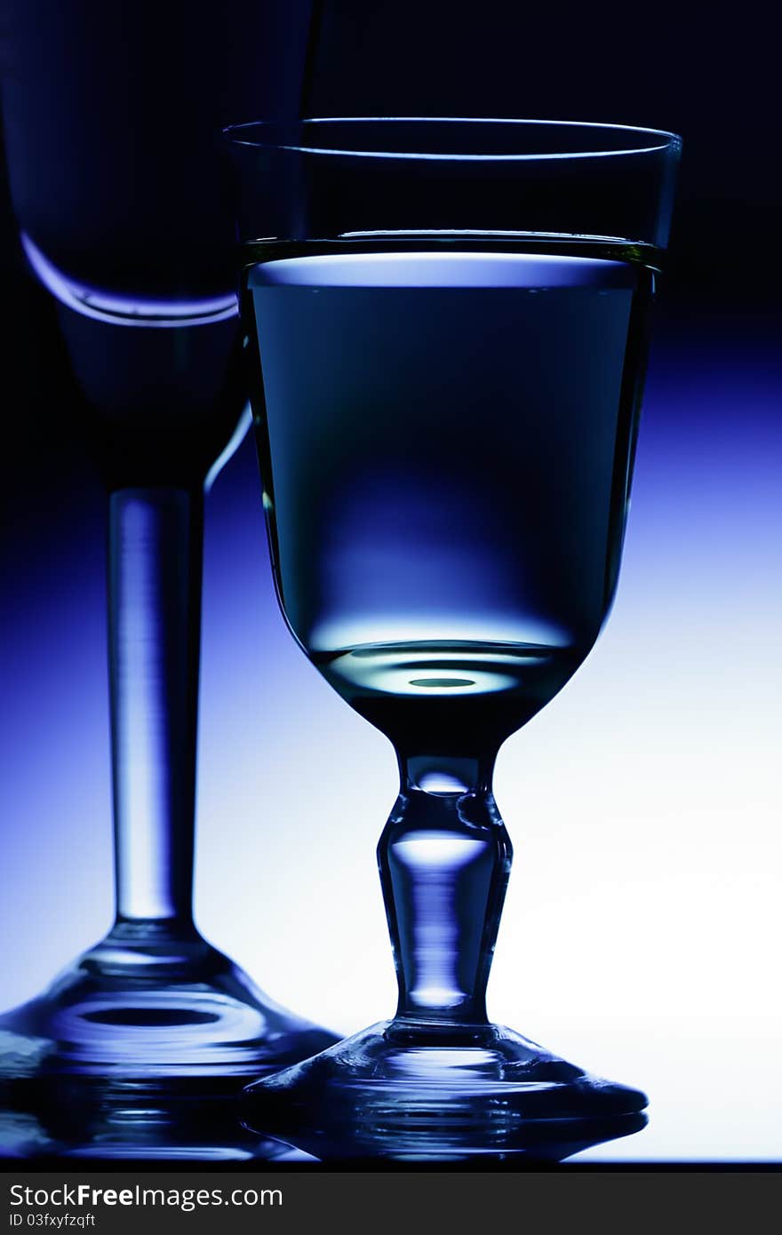 Wine-glasses on a dark blue background.