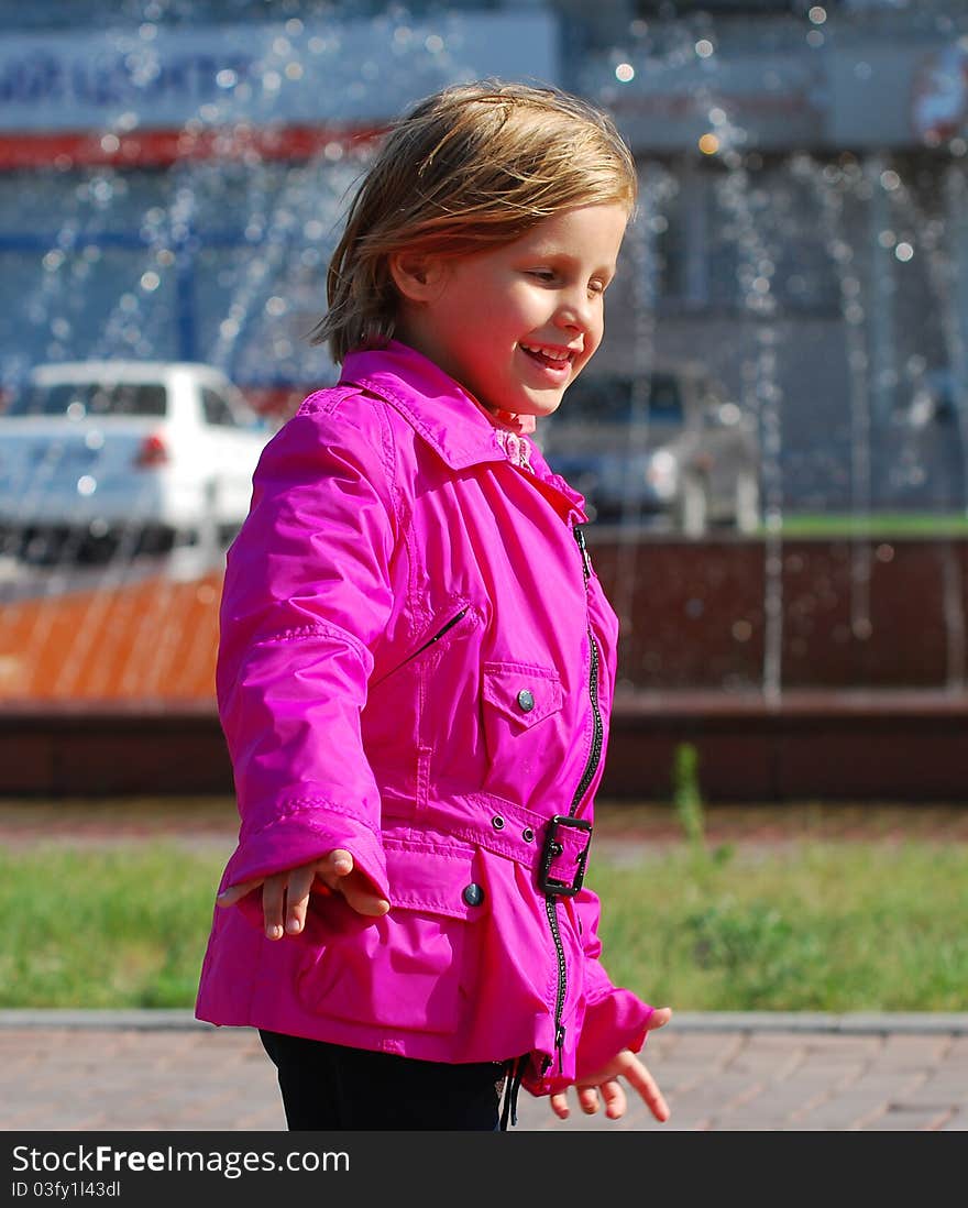 Smiling little girl walking down the street. Smiling little girl walking down the street