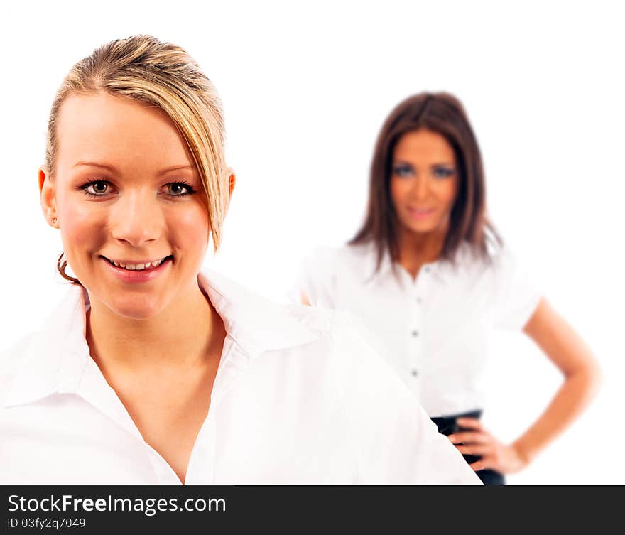 Two buisness women one completely in focus the other blurred on isloated white background. Two buisness women one completely in focus the other blurred on isloated white background