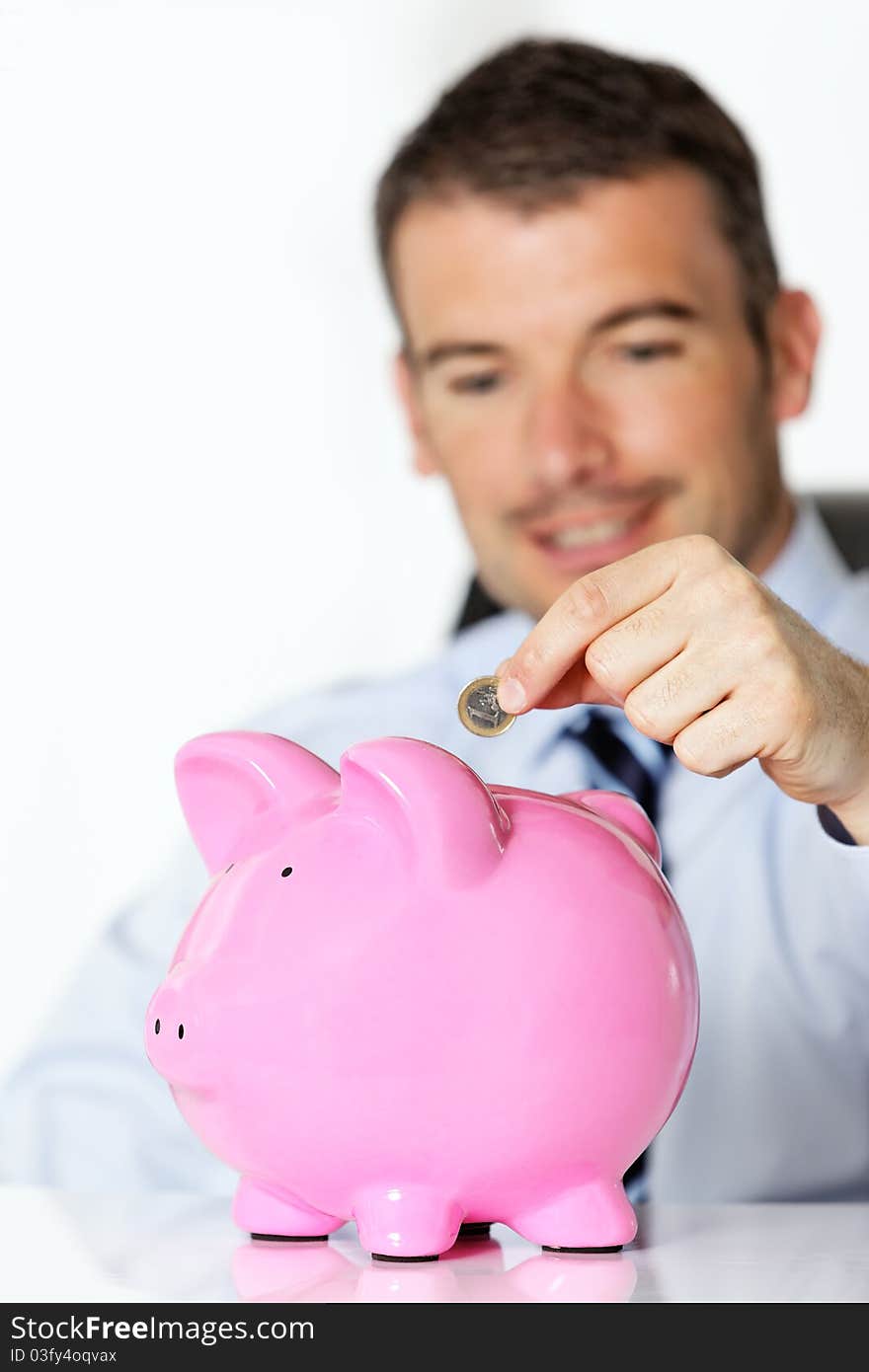 Man with pink piggy bank. Man with pink piggy bank