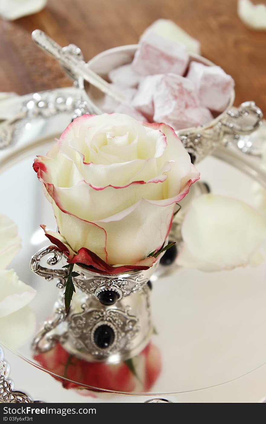 East sweets on silver ware with rose. East sweets on silver ware with rose