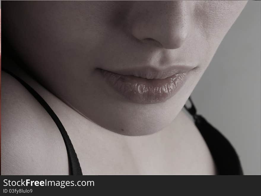 Black-and-white portrait of lips of the girl.