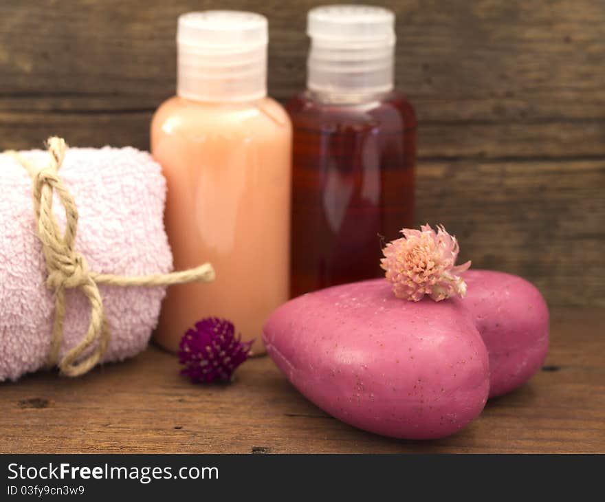 With pink soap on the wooden background. With pink soap on the wooden background