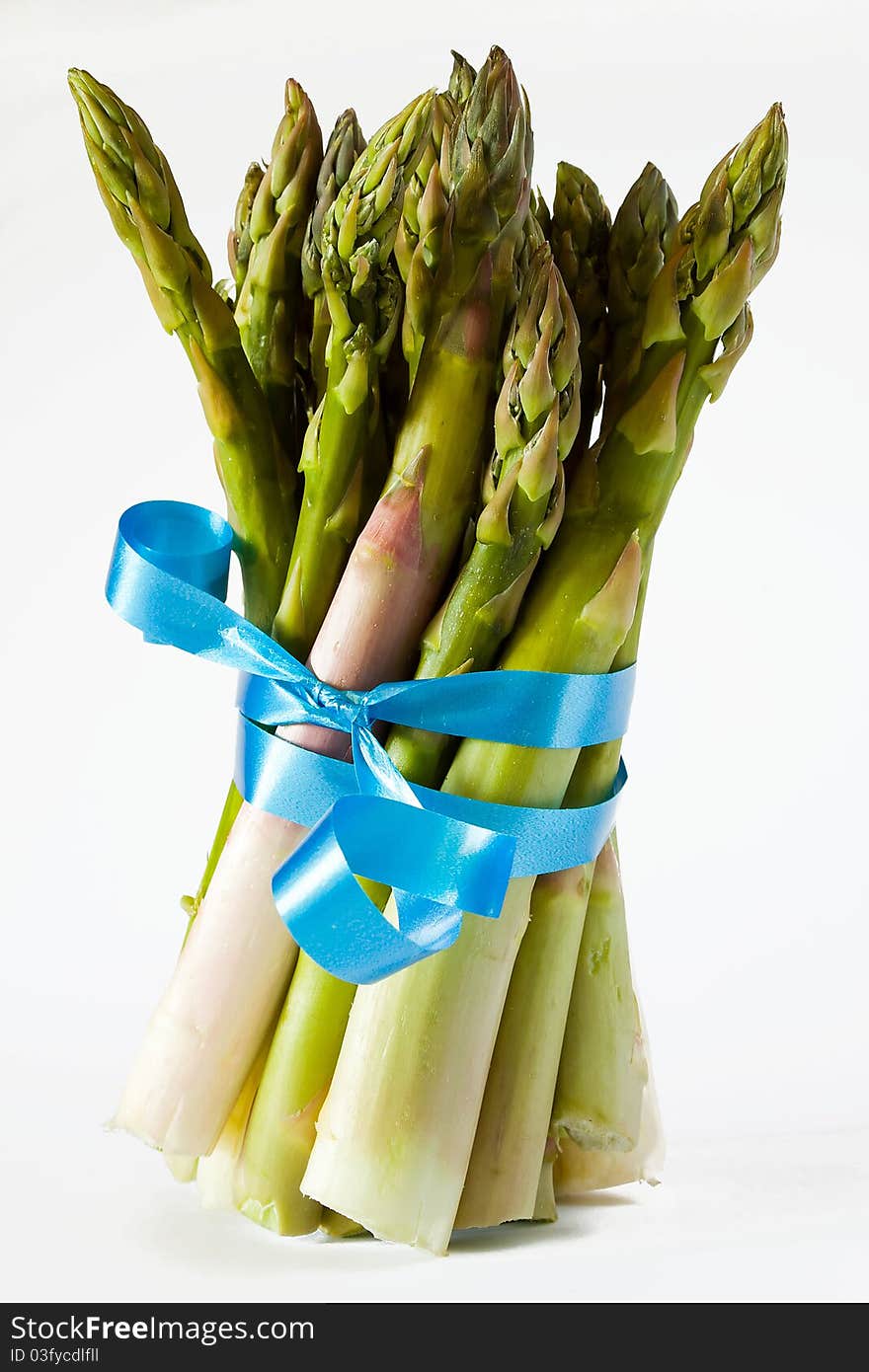 Closeup of bunch of asparagus with blue ribbon