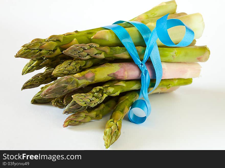 Closeup of bunch of asparagus with blue ribbon