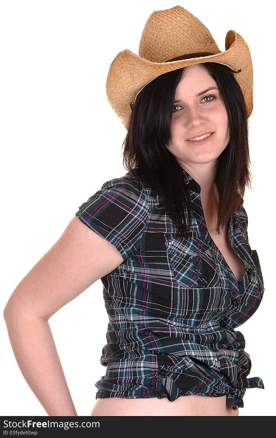 A lovely young woman in a blue blouse and straw cowboy hat standing in the studio for white background. A lovely young woman in a blue blouse and straw cowboy hat standing in the studio for white background.