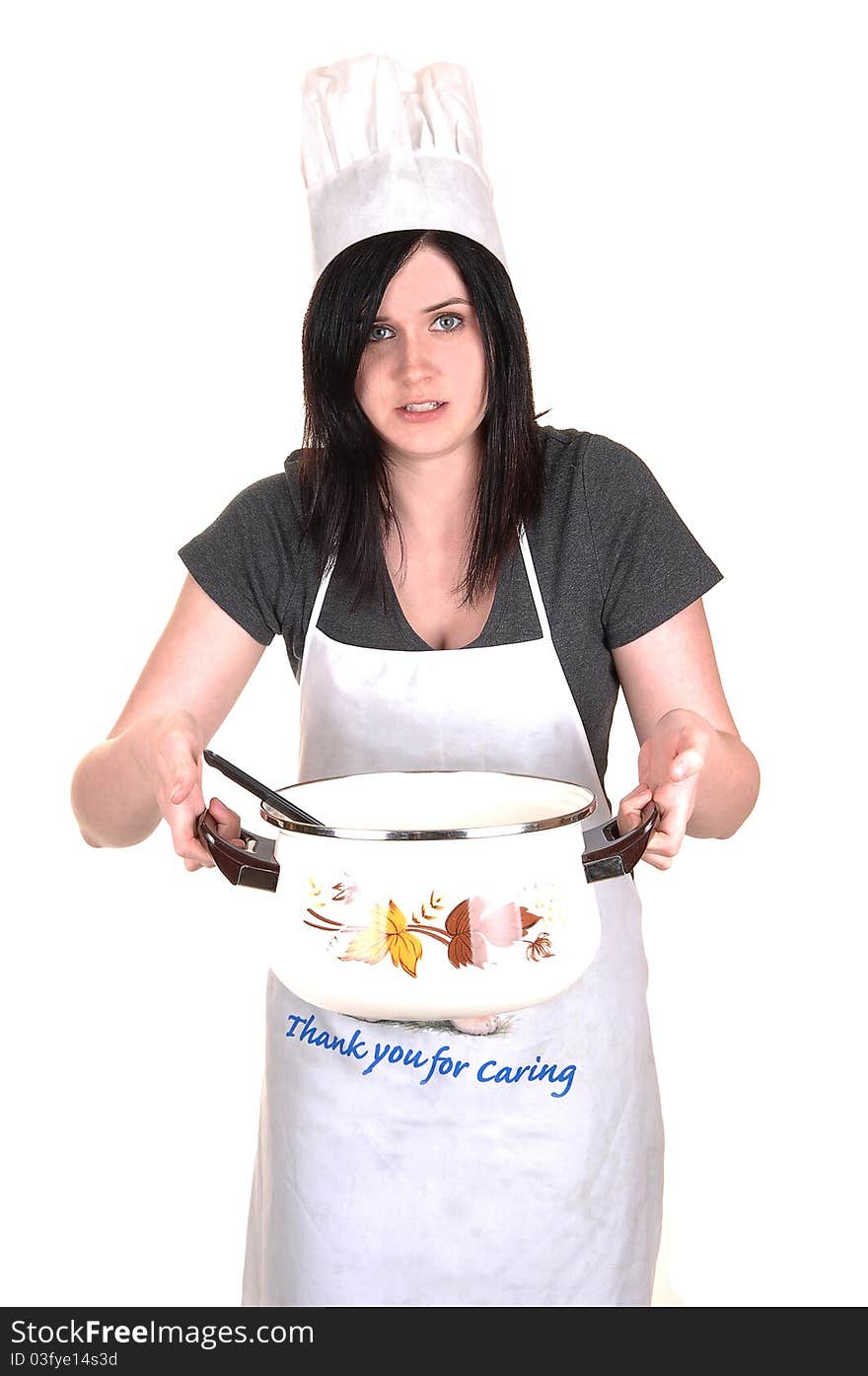 A pretty young woman, holding a hot cook pot, standing with an apron, black hair and a cook hat for white background. A pretty young woman, holding a hot cook pot, standing with an apron, black hair and a cook hat for white background.